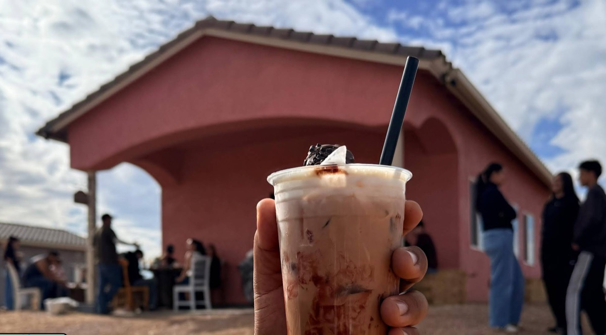 Iced coffee with the pink house in the background